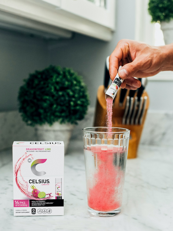 image of a celsius on the go powder being poured into a water cup